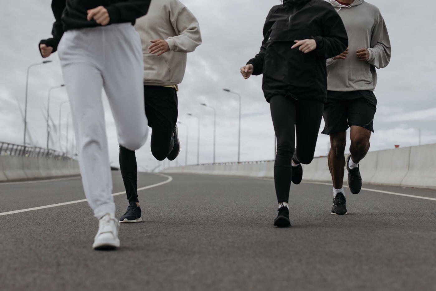 a people jugging together on a road