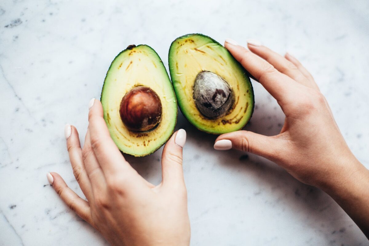 person holding sliced avocado